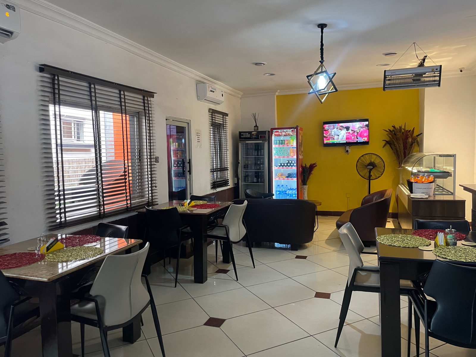 Dining area inside the Trendy Inn restaurant with set tables and lounge seating